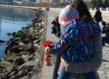 Baku residents bringing flowers to Seaside Boulevard to honor missing oil workers.  Azerbaijan, Dec.07, 2015